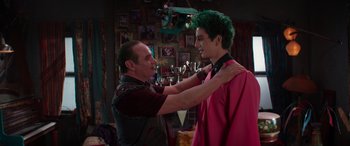 Movie still from “Zombies 3” (2022), directed by Paul Hoen – A man and a young man are fixing each other's shirt; Medium shot, Over the shoulder angle