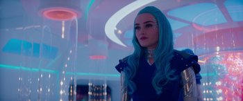 Movie still from “Zombies 3” (2022), directed by Paul Hoen – A woman with blue hair standing in a room; Close Up shot, Over the shoulder angle