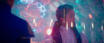 Movie still from “Zombies 3” (2022), directed by Paul Hoen – A woman is looking at a light show; Medium shot, Over the shoulder angle