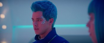 Movie still from “Zombies 3” (2022), directed by Paul Hoen – A man with blue hair is looking to his left; Close Up shot, Over the shoulder angle