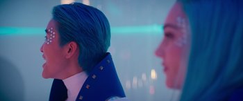Movie still from “Zombies 3” (2022), directed by Paul Hoen – A man and a woman with bright blue hair; Close Up shot, Over the shoulder angle