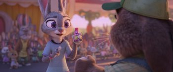 Movie still from “Zootopia” (2016), directed by Jared Bush – A woman holding a cell phone in front of a man; Close Up shot, Over the shoulder angle