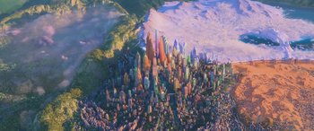 Movie still from “Zootopia” (2016), directed by Jared Bush – An aerial view of a large city with a mountain in the background; Extreme Wide shot, High angle
