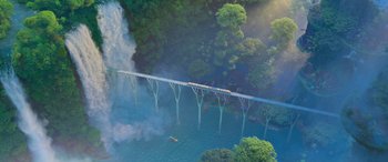 Movie still from “Zootopia” (2016), directed by Jared Bush – An aerial view of a train crossing a bridge; Extreme Wide shot, Overhead angle