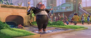 Movie still from “Zootopia” (2016), directed by Jared Bush – A statue of a hippo wearing a suit and tie; Wide shot, Low angle
