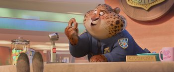 Movie still from “Zootopia” (2016), directed by Jared Bush – A police officer in uniform is pointing to a pretzel; Medium shot, Over the shoulder angle