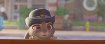 Movie still from “Zootopia” (2016), directed by Jared Bush – A cat wearing a police hat looking at the camera; Close Up shot, Over the shoulder angle