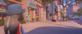 Movie still from “Zootopia” (2016), directed by Jared Bush – An animated character is walking down the street; Wide shot, High angle