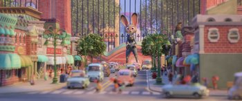 Movie still from “Zootopia” (2016), directed by Jared Bush – An animated scene of a street with cars and a bunny; Wide shot, Over the shoulder angle