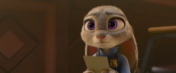 Movie still from “Zootopia” (2016), directed by Jared Bush – A rabbit is holding a piece of paper; Close Up shot, Over the shoulder angle