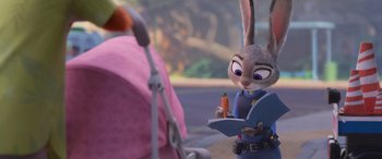 Movie still from “Zootopia” (2016), directed by Jared Bush – A bunny rabbit holding a carrot in his hand; Close Up shot, Over the shoulder angle