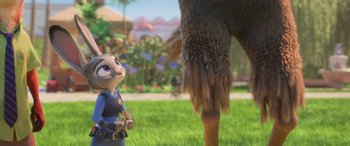 Movie still from “Zootopia” (2016), directed by Jared Bush – A woman standing in front of an animal in the grass; Medium shot, Over the shoulder angle