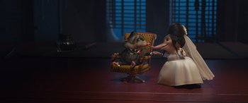 Movie still from “Zootopia” (2016), directed by Jared Bush – An animal sitting in a chair next to a woman; Wide shot, High angle