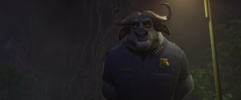 Movie still from “Zootopia” (2016), directed by Jared Bush – An animated character in a police uniform with horns on his head; Medium shot, Over the shoulder angle