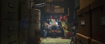 Movie still from “Zootopia” (2016), directed by Jared Bush – A group of people that are sitting at a computer desk; Wide shot, High angle