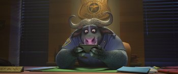 Movie still from “Zootopia” (2016), directed by Jared Bush – A character in a police uniform holding a cell phone; Medium shot, High angle