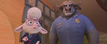 Movie still from “Zootopia” (2016), directed by Jared Bush – A man and a woman are standing next to each other in a room; Medium shot, Over the shoulder angle