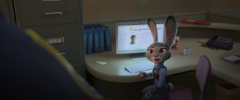 Movie still from “Zootopia” (2016), directed by Jared Bush – A bunny rabbit sitting in front of a computer screen; Medium shot, High angle