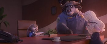 Movie still from “Zootopia” (2016), directed by Jared Bush – Two characters sitting at a table together; Medium shot, Over the shoulder angle