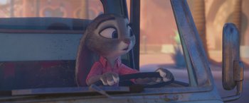 Movie still from “Zootopia” (2016), directed by Jared Bush – A person sitting in the driver's seat of a car; Close Up shot, Over the shoulder angle