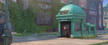 Movie still from “Zootopia” (2016), directed by Jared Bush – An old green building has a sign on it; Extreme Wide shot, Low angle