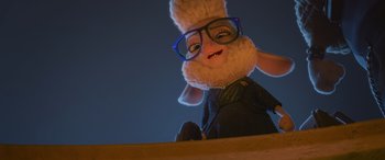 Movie still from “Zootopia” (2016), directed by Jared Bush – A stuffed animal wearing glasses sitting on top of a table; Medium shot, Low angle