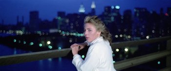 Movie still from “1990: The Bronx Warriors” (1982), directed by Enzo G. Castellari – A woman standing in front of a city at night; Medium shot, Low angle