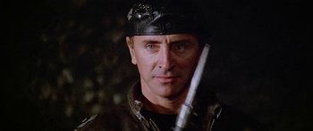 Movie still from “1990: The Bronx Warriors” (1982), directed by Enzo G. Castellari – A person holding a gun in his hand; Close Up shot, Low angle