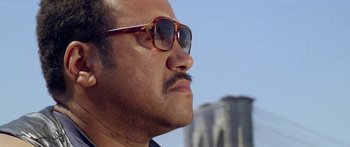 Movie still from “1990: The Bronx Warriors” (1982), directed by Enzo G. Castellari – A person wearing a pair of sunglasses; Close Up shot, Low angle