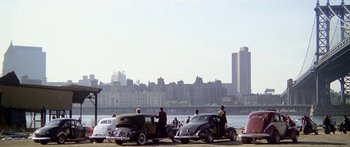 Movie still from “1990: The Bronx Warriors” (1982), directed by Enzo G. Castellari – A group of people standing next to a body of water; Extreme Wide shot, High angle