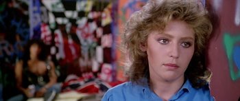 Movie still from “1990: The Bronx Warriors” (1982), directed by Enzo G. Castellari – A person wearing a blue shirt; Close Up shot, Over the shoulder angle