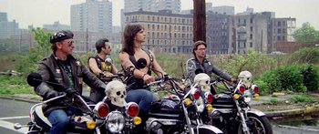 Movie still from “1990: The Bronx Warriors” (1982), directed by Enzo G. Castellari – A group of people riding motorcycles in a city; Wide shot, Low angle