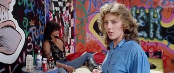 Movie still from “1990: The Bronx Warriors” (1982), directed by Enzo G. Castellari – A woman in a blue shirt and a man in a blue shirt; Medium shot, Over the shoulder angle