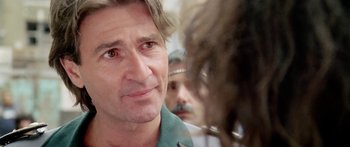 Movie still from “1990: The Bronx Warriors” (1982), directed by Enzo G. Castellari – A man's face as he looks at another man; Close Up shot, Over the shoulder angle