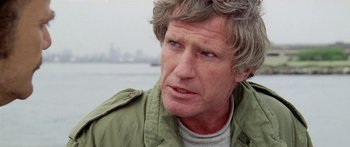 Movie still from “1990: The Bronx Warriors” (1982), directed by Enzo G. Castellari – A person wearing a green jacket; Close Up shot, Over the shoulder angle