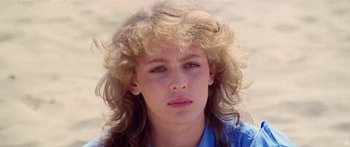 Movie still from “1990: The Bronx Warriors” (1982), directed by Enzo G. Castellari – A young woman with long blonde hair wearing a blue shirt; Close Up shot, Low angle