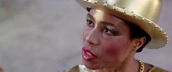 Movie still from “1990: The Bronx Warriors” (1982), directed by Enzo G. Castellari – A person wearing a hat; Close Up shot, Over the shoulder angle