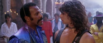 Movie still from “1990: The Bronx Warriors” (1982), directed by Enzo G. Castellari – A man and a woman face to face in a crowd of onlookers; Close Up shot, Over the shoulder angle