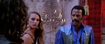 Movie still from “1990: The Bronx Warriors” (1982), directed by Enzo G. Castellari – A man and a woman standing next to each other in front of candles; Close Up shot, Low angle