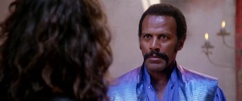 Movie still from “1990: The Bronx Warriors” (1982), directed by Enzo G. Castellari – A man in a blue shirt looking at a woman in a blue shirt; Close Up shot, Over the shoulder angle
