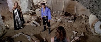 Movie still from “1990: The Bronx Warriors” (1982), directed by Enzo G. Castellari – A man standing in the middle of a room; Wide shot, Over the shoulder angle