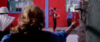 Movie still from “1990: The Bronx Warriors” (1982), directed by Enzo G. Castellari – A man holding a baseball bat while standing next to another man; Wide shot, Over the shoulder angle