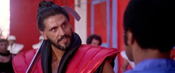 Movie still from “1990: The Bronx Warriors” (1982), directed by Enzo G. Castellari – A person wearing a costume; Close Up shot, Over the shoulder angle