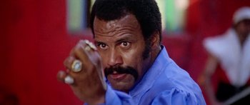 Movie still from “1990: The Bronx Warriors” (1982), directed by Enzo G. Castellari – A person holding a cell phone; Close Up shot, Low angle