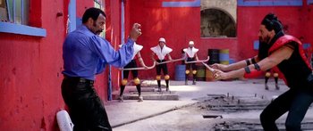 Movie still from “1990: The Bronx Warriors” (1982), directed by Enzo G. Castellari – A group of men playing a game of tug - o - war; Wide shot, Over the shoulder angle