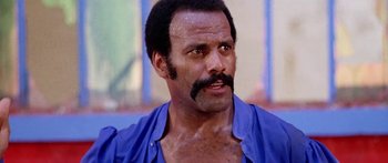 Movie still from “1990: The Bronx Warriors” (1982), directed by Enzo G. Castellari – A person with a mustache; Close Up shot, Low angle