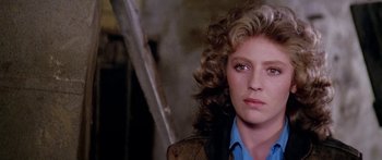 Movie still from “1990: The Bronx Warriors” (1982), directed by Enzo G. Castellari – A person with curly hair; Close Up shot, Over the shoulder angle