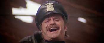 Movie still from “1990: The Bronx Warriors” (1982), directed by Enzo G. Castellari – A person wearing a hat; Close Up shot, Low angle