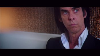 Movie still from “20,000 Days on Earth” (2014), directed by Iain Forsyth – A person wearing a suit and tie; Close Up shot, Low angle