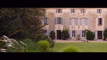 Movie still from “20,000 Days on Earth” (2014), directed by Iain Forsyth – An image of an old building in the middle of a yard; Extreme Wide shot, High angle